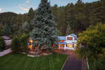 Nestled amidst a lush forest, this stunning white home offers a serene retreat.