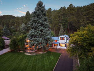 Nestled amidst a lush forest, this stunning white home offers a serene retreat.