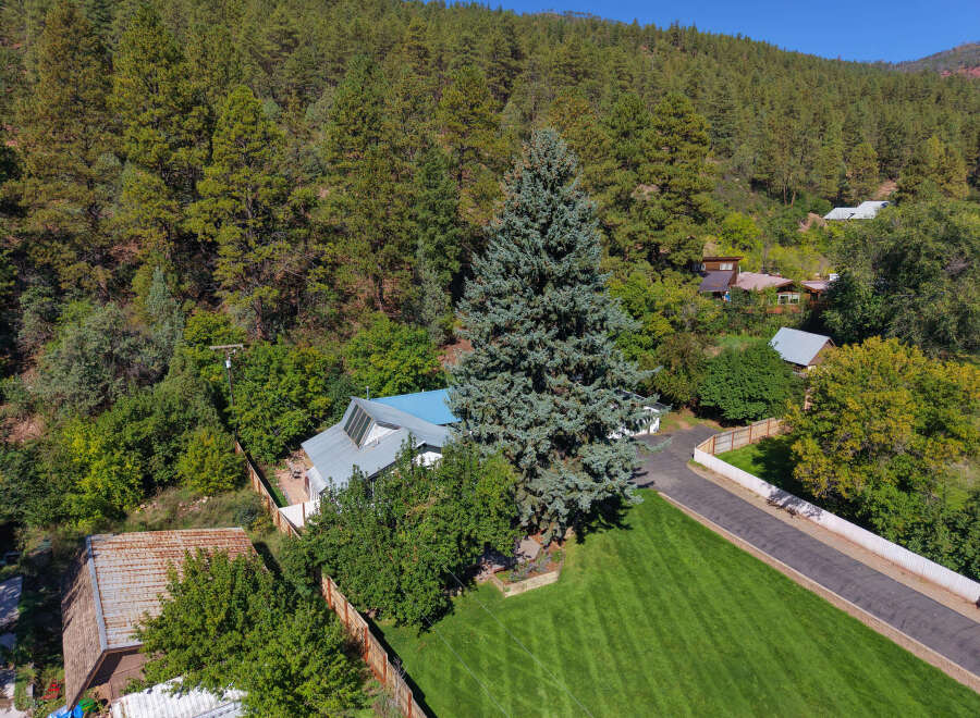 Discover this charming property nestled amidst a lush, wooded hillside.