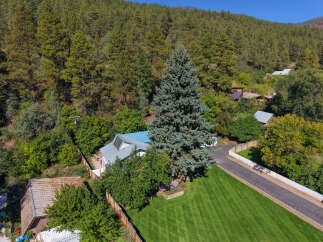 Discover this charming property nestled amidst a lush, wooded hillside.