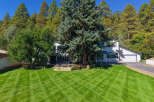Nestled amidst a backdrop of mature pine trees and lush greenery, this stunning property offers a serene retreat.