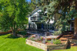 Enjoy outdoor living with this expansive deck, perfect for entertaining, featuring a large dining set and a fire pit.