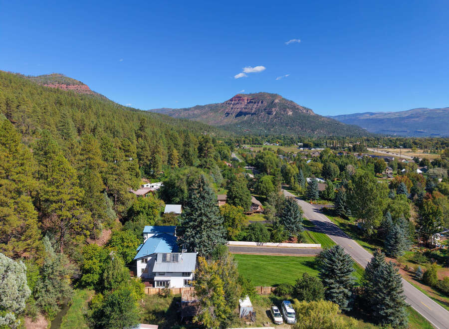 Nestled amidst lush pine trees and rolling hills, this property offers a serene mountain retreat.