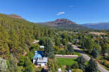 Nestled amidst lush pine trees and rolling hills, this property offers a serene mountain retreat.