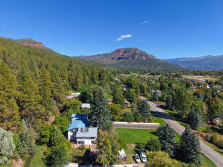 Nestled amidst lush pine trees and rolling hills, this property offers a serene mountain retreat.