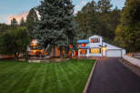 Nestled amidst towering trees, this stunning white home offers a serene retreat.