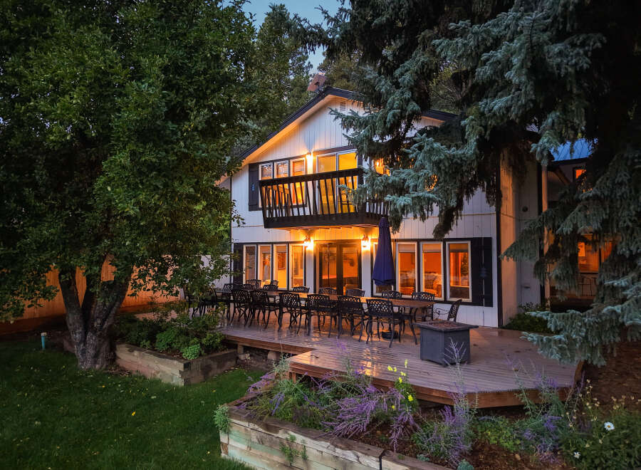 Enjoy evenings on the expansive deck of this charming home, perfect for entertaining guests or relaxing with family.