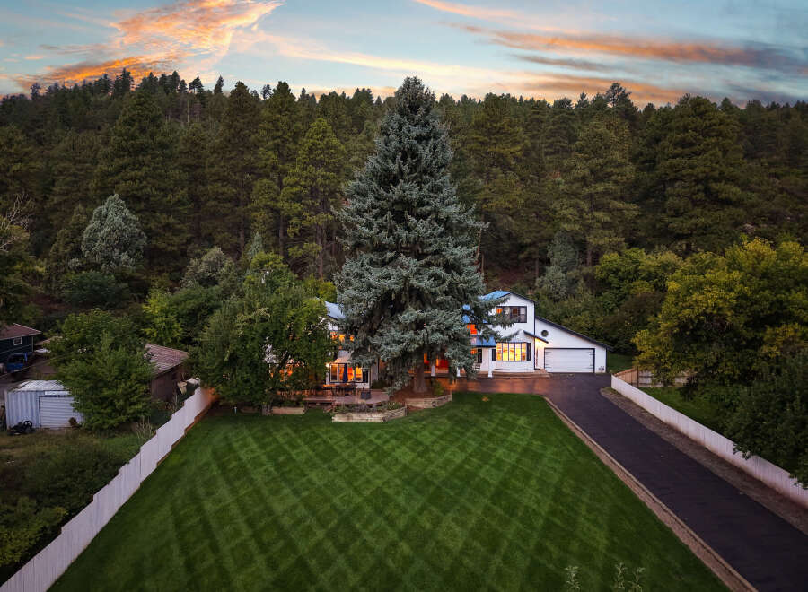 Nestled amidst a lush forest, this stunning property offers a serene retreat with its picturesque setting and inviting architecture.