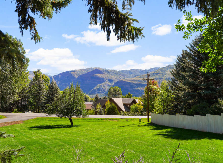 Experience the serene beauty of this property, nestled amidst lush greenery and mature trees.