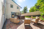 Enjoy outdoor living with this spacious patio featuring comfortable seating and a relaxing hot tub.