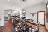 This spacious dining area features a large, rustic wooden table with seating for eight, perfect for family gatherings and entertaining.
