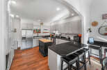 This spacious kitchen boasts elegant gray cabinetry and sleek black granite countertops, perfect for any home chef.