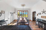 This spacious dining room features a large wooden table with seating for ten, perfect for hosting gatherings.