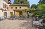 Enjoy outdoor living with this charming patio featuring a vine-covered pergola, perfect for al fresco dining or relaxation.