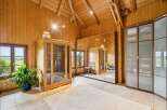 Experience ultimate relaxation in this stunning wooden room featuring a modern glass-enclosed sauna.