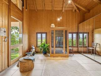 Experience ultimate relaxation and fitness in this beautifully appointed wooden room, featuring a modern infrared sauna and a rowing machine.