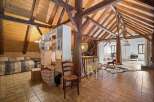Discover this charming attic space, featuring exposed wooden beams and a vaulted ceiling that adds rustic character.