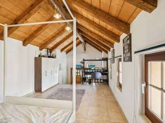 Experience rustic charm and modern comfort in this unique attic bedroom.