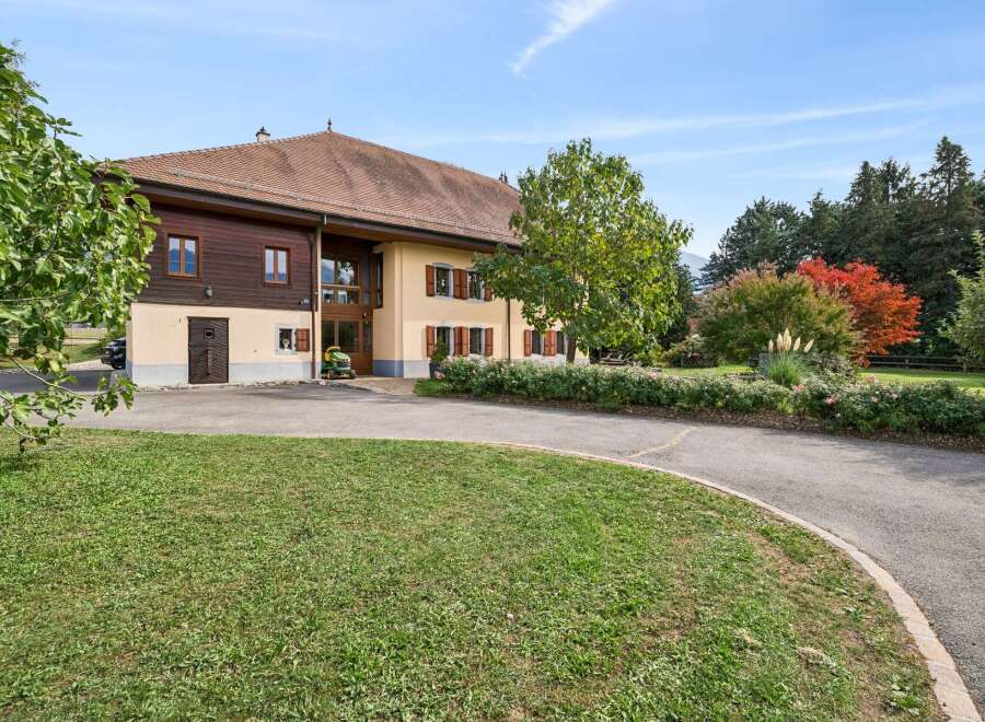 Discover this charming property featuring a beautiful home with traditional wooden accents and a warm, inviting facade.