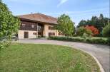 Discover this charming property featuring a beautiful home with traditional wooden accents and a warm, inviting facade.