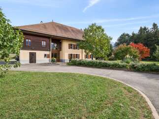Discover this charming property featuring a beautiful home with traditional wooden accents and a warm, inviting facade.