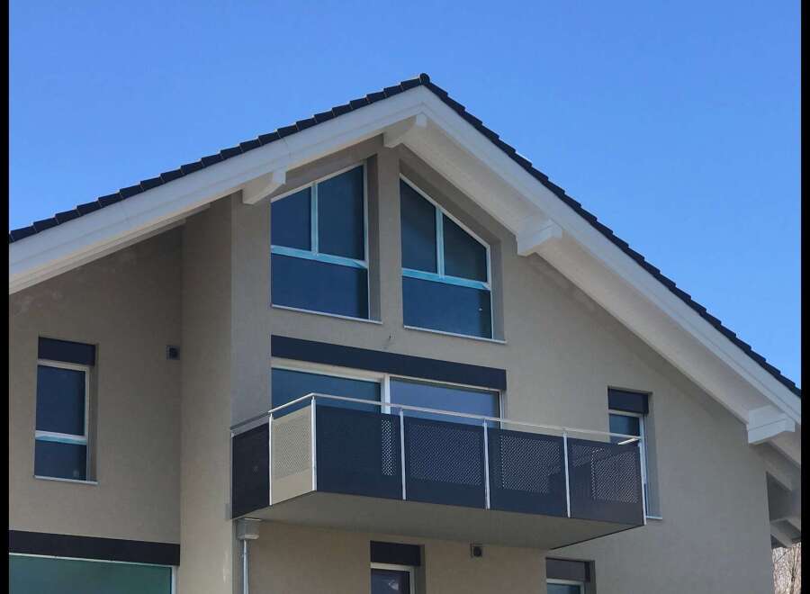 Discover modern living in this stunning home featuring a sleek balcony perfect for enjoying the outdoors.