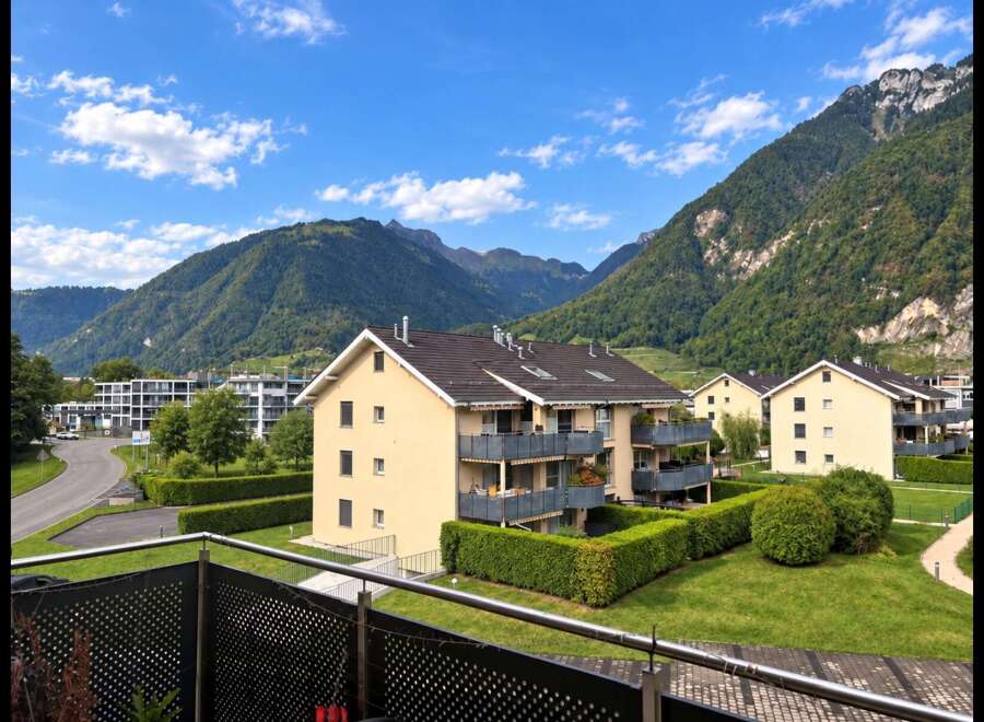Experience modern living in this stunning apartment complex nestled against a backdrop of majestic mountains.