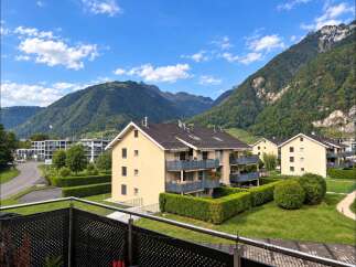 Experience modern living in this stunning apartment complex nestled against a backdrop of majestic mountains.
