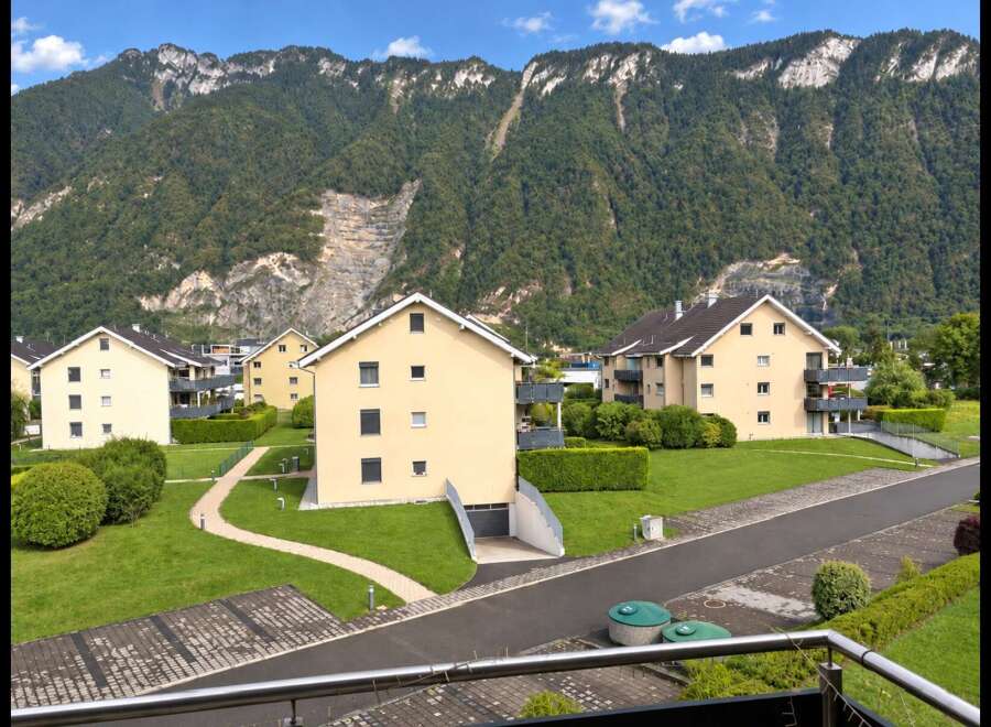Discover modern living in this scenic residential complex nestled against a majestic mountain backdrop.