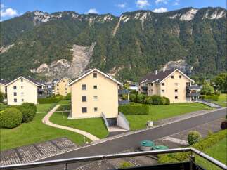 Discover modern living in this scenic residential complex nestled against a majestic mountain backdrop.