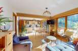 Experience the perfect blend of modern comfort and rustic charm in this inviting open-plan living space.
