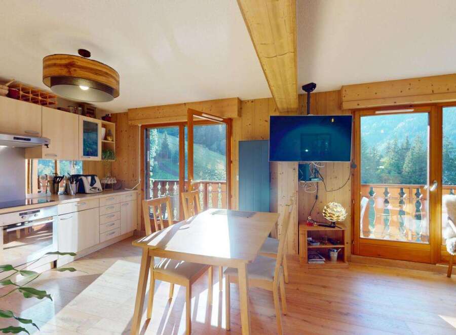 Experience the charm of this alpine retreat, featuring a fully equipped kitchen with modern appliances and ample cabinet space.