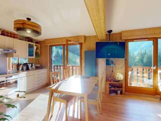 Experience the charm of this alpine retreat, featuring a fully equipped kitchen with modern appliances and ample cabinet space.