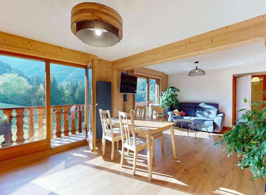 Experience breathtaking mountain views from this charming wooden interior living space.