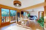 Experience breathtaking mountain views from this charming wooden interior living space.