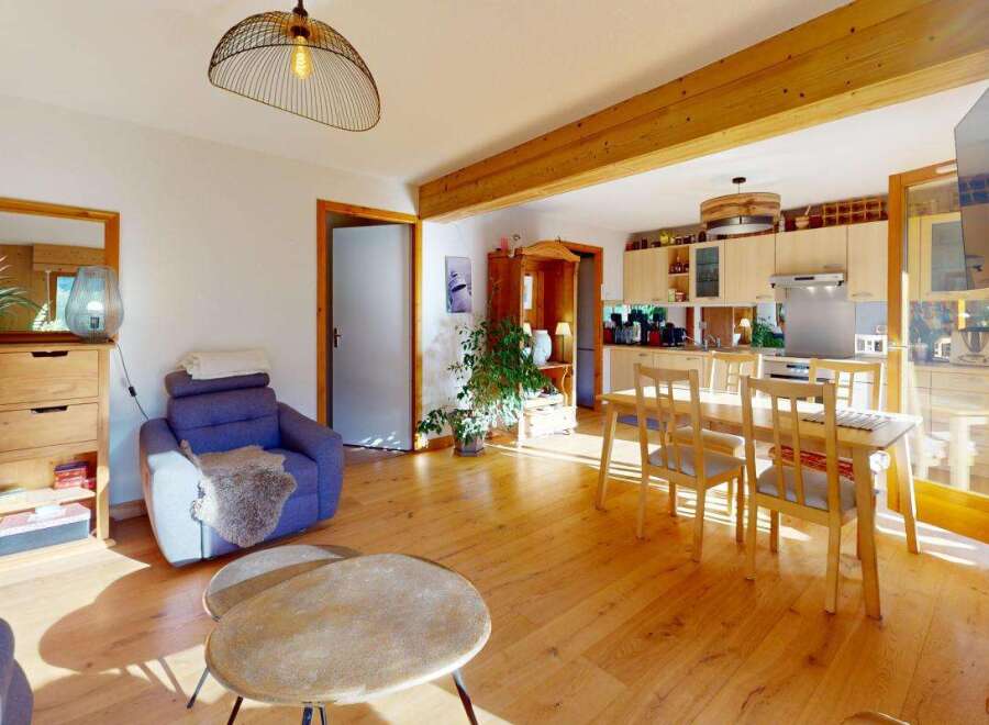 Experience open-concept living in this charming home, featuring a seamless flow between the living area and a well-appointed kitchen.