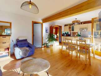 Experience open-concept living in this charming home, featuring a seamless flow between the living area and a well-appointed kitchen.