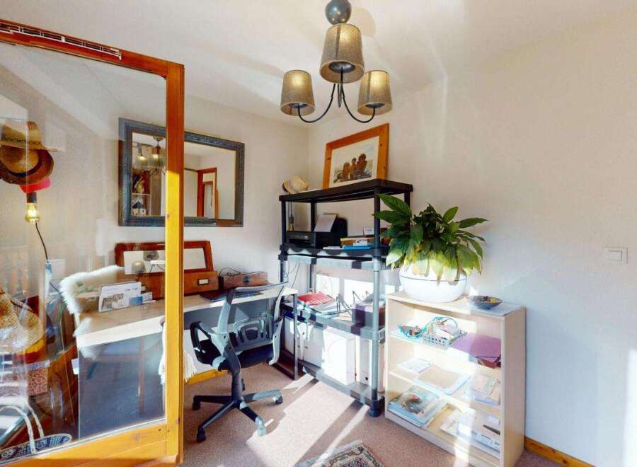 This home office space offers a dedicated area for work and creativity, featuring a functional desk and comfortable office chair.