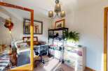 This home office space offers a dedicated area for work and creativity, featuring a functional desk and comfortable office chair.