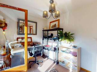 This home office space offers a dedicated area for work and creativity, featuring a functional desk and comfortable office chair.