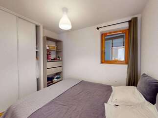 This cozy bedroom features a spacious sliding door wardrobe, perfect for ample storage.