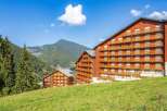 Experience the charm of mountain living in this stunning property, featuring a classic wooden facade and multiple balconies offering breathtaking views.