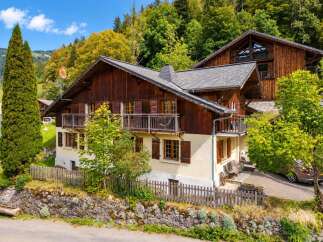 Nestled in a picturesque mountain setting, this charming wooden chalet offers a serene retreat.
