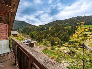 Enjoy breathtaking mountain views from the comfort of your private balcony, complete with a comfortable chair for relaxation.