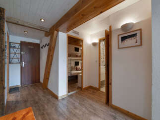 This charming apartment features a rustic wooden interior with exposed beams and a cozy ambiance.