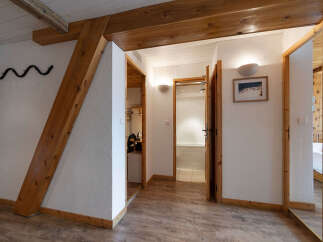 This charming interior features exposed wooden beams and a rustic aesthetic, creating a warm and inviting atmosphere.
