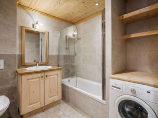 Experience rustic charm in this bathroom featuring a wooden vanity with a vessel sink and a mirror above.