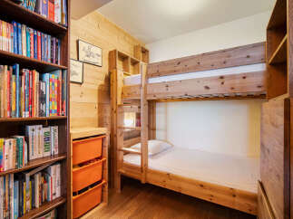 This charming room features a cozy bunk bed, perfect for families or groups.