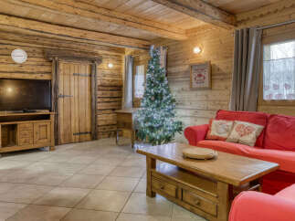 Experience the cozy charm of this rustic log cabin living room, perfect for a winter getaway.