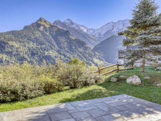Experience breathtaking mountain vistas from this stunning property, featuring a spacious patio perfect for enjoying the alpine scenery.